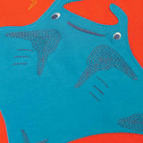 A super close up of the ray on the front of the Frugi orange children's jumper. The blue ray has embroidered details on it.