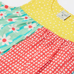 A close up of the front of the Frugi Summer Printed Dungaree in the Rainbow Hotchpotch print.