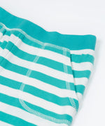 Close up of the Frugi kids sunny sea moss short - showing the front pocket and blue waist band on blue and white stripe organic cotton fabric