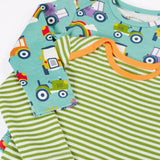 Close up of the Frugi super special 2 Pack long sleeves baby body. One has a light green and white , one has an all over terrific tractors print.
