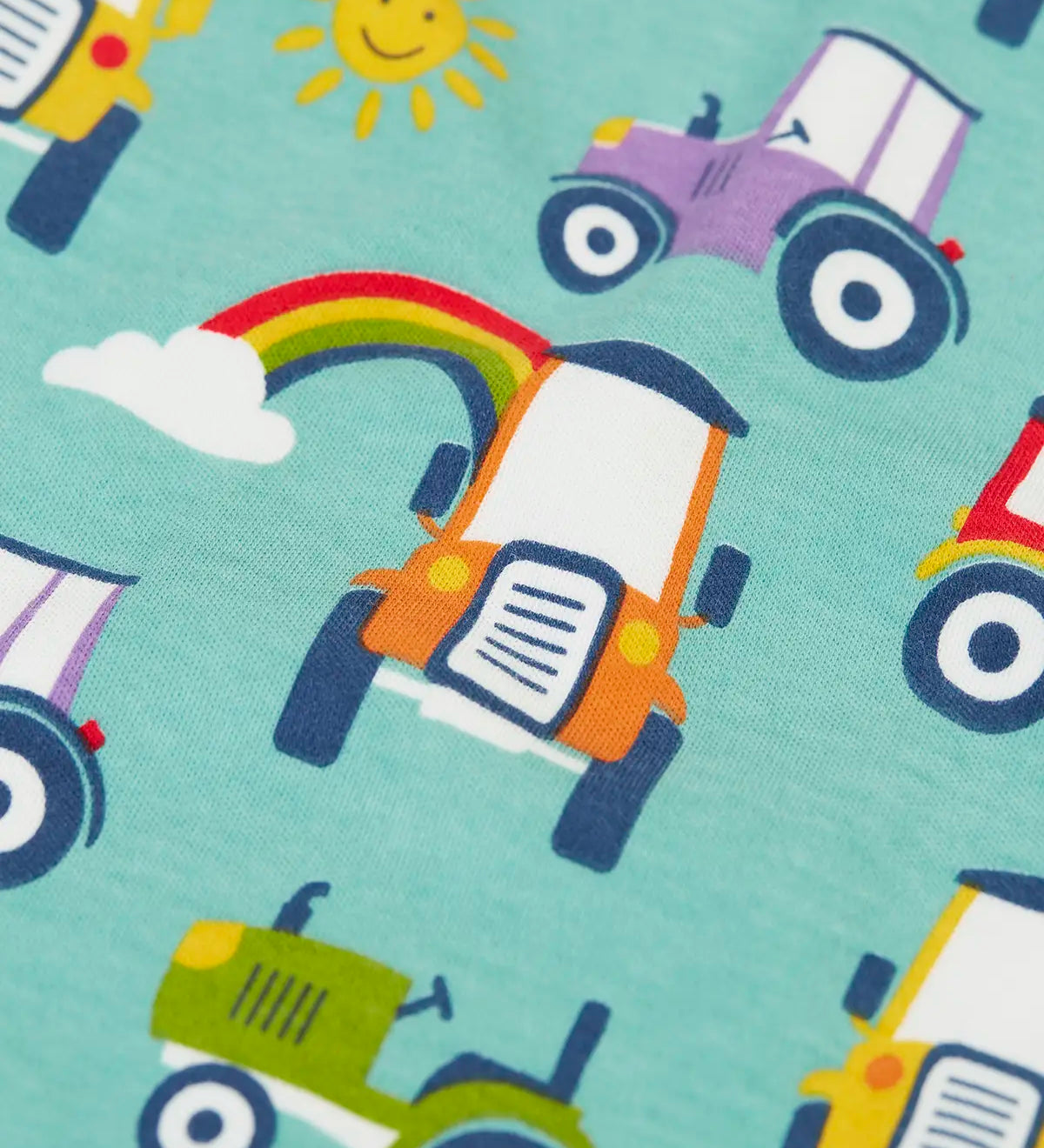 Close up of the terrific tractors print on one of the vest from the Frugi super special 2 Pack long sleeves baby body.