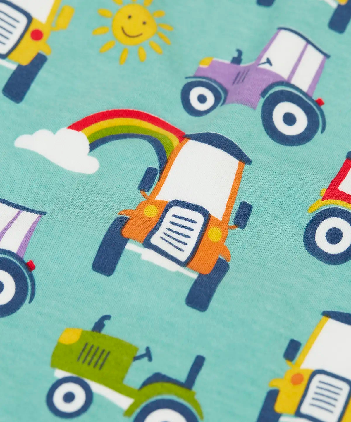 Close up of the terrific tractors print on one of the vest from the Frugi super special 2 Pack long sleeves baby body.