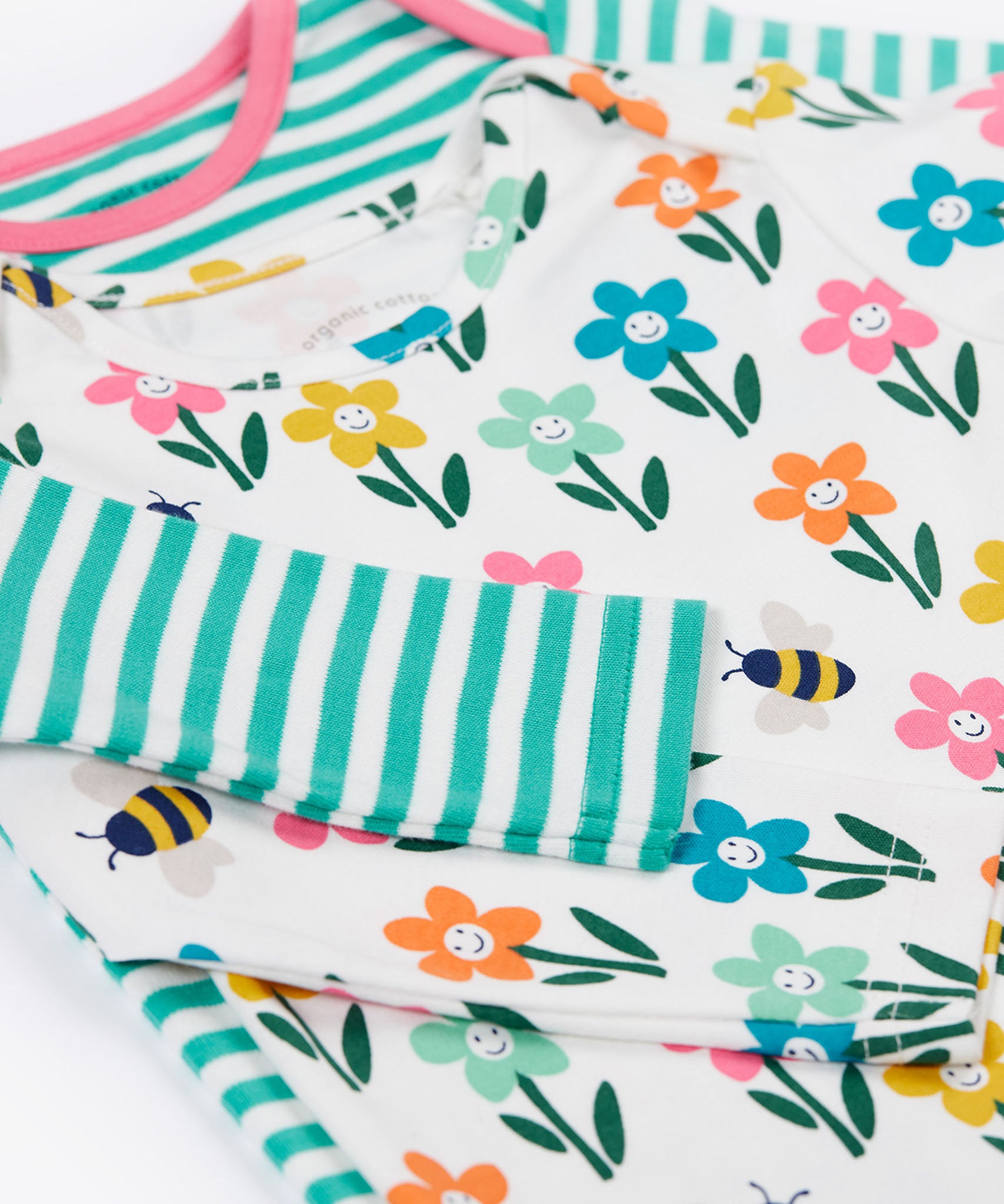 A close up view of a set of two Frugi super special long sleeved organic cotton baby vests.