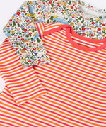 Close up of the front of the Frugi super special 2 Pack long sleeved organic cotton baby body. One has a pink, orange and white stripe, the other had an all over highland fields print.  