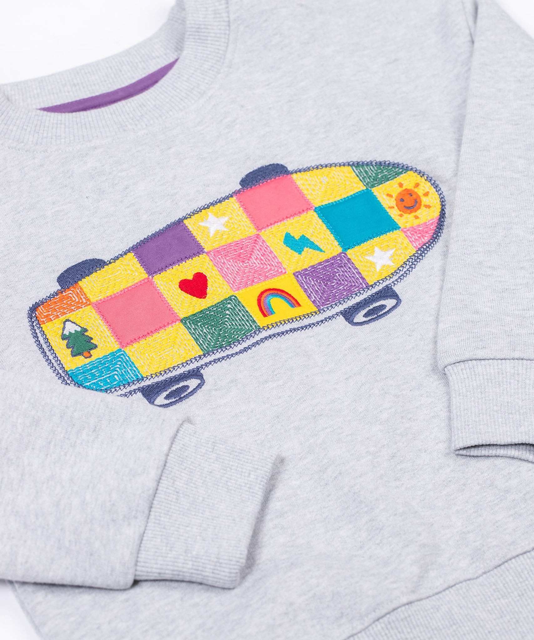 A zoomed in view of the  Frugi Superb Stitched Skateboard sweatshirt. This organic cotton long sleeved, marl grey coloured jumper features a colourful skateboard design on the front.