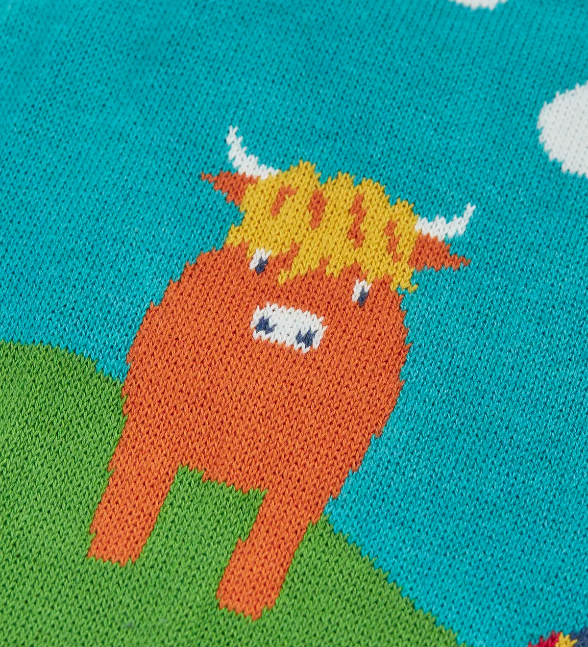 Close up of the highland coo cow on the Frugi Tavi knitted tank top with a highland scenes design.
