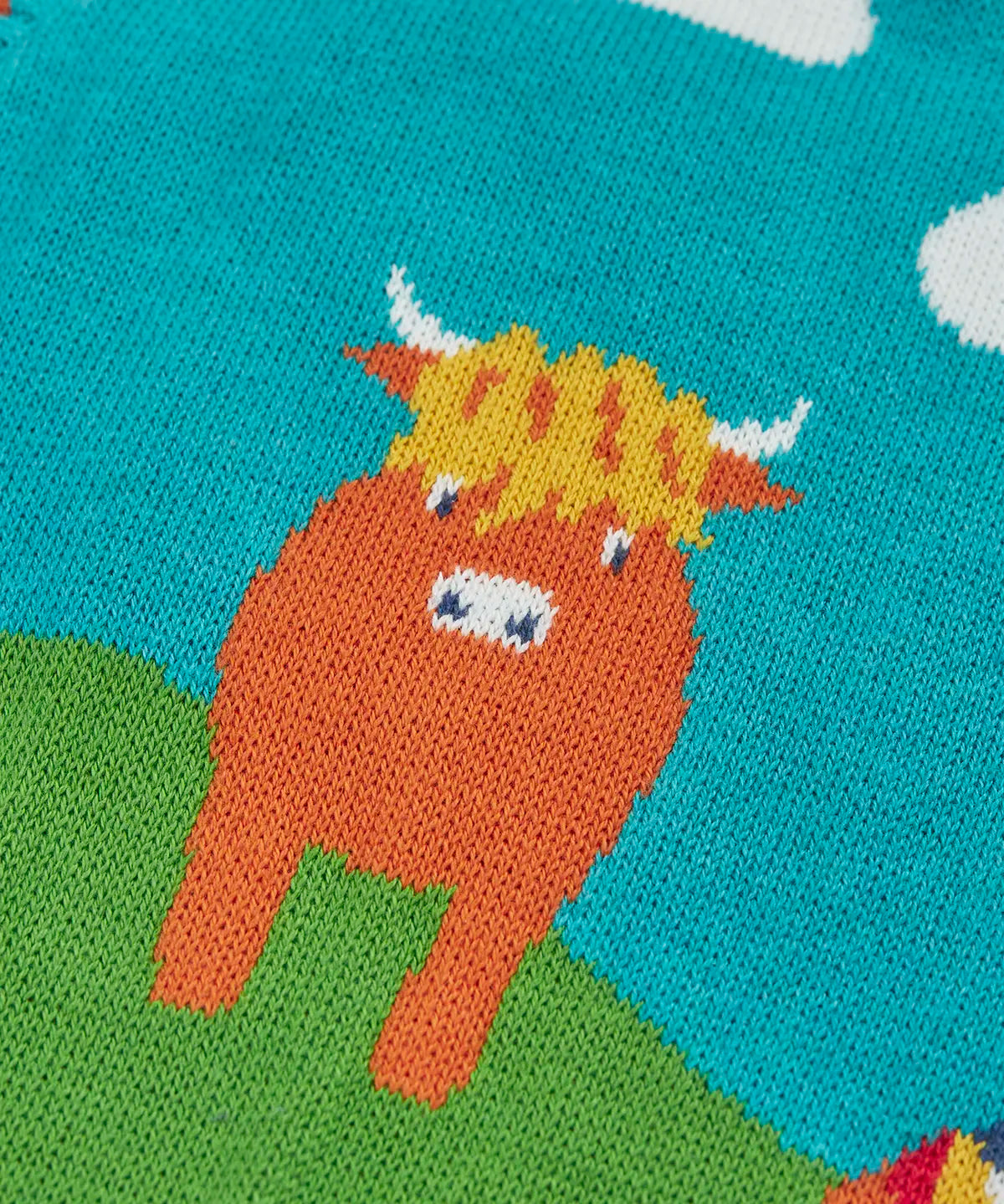 Close up of the highland coo cow on the Frugi Tavi knitted tank top with a highland scenes design.