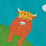 Close up of the highland coo cow on the Frugi Tavi knitted tank top with a highland scenes design.