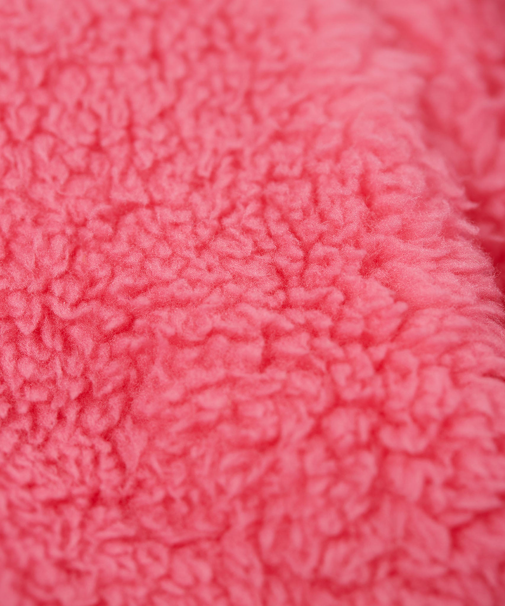 A close up of the Frugi kids ted fleece hoodie in boat blue/flowers showing the bright pink ted fleece inner detail on  100% Oeko-Tex cotton fabric