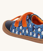 A side view of the Frugi Penguin Print Tide Low Top velcro closure leather children's shoes showing the velcro strip closure. 