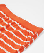A close up of Frugi Stithian Shorts in Tiger Orange Breton's front pocket.