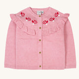 Frugi pink marl coloured romi cardigan with red mushroom details. Th egardigan has a pink ruffle with red toadstool above teh ruffle.