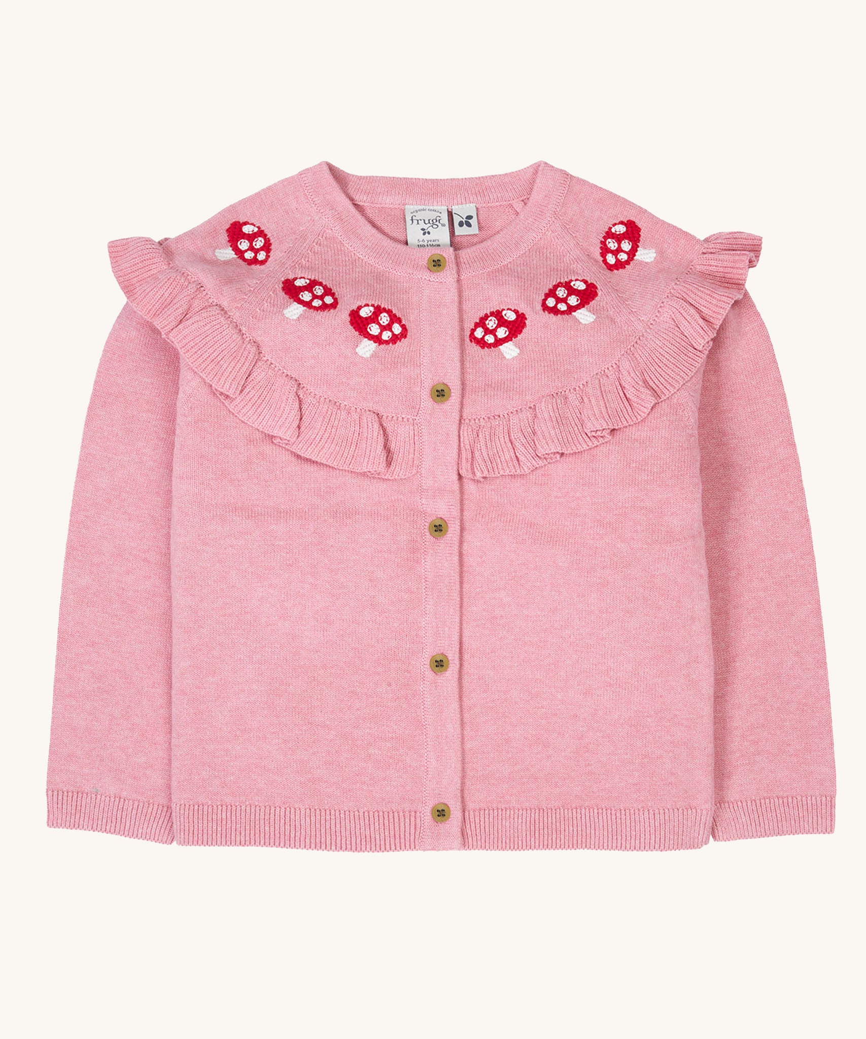Frugi pink marl coloured romi cardigan with red mushroom details. Th egardigan has a pink ruffle with red toadstool above teh ruffle.