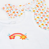 A close up of the fronts of the Frugi varlie bloom vest 2 pack multipack. One vest has an all over flower print on a white background with the other featuring a rainbow and flower graphic in the middle of the chest area on a white background. 