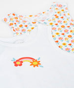 A close up of the fronts of the Frugi varlie bloom vest 2 pack multipack. One vest has an all over flower print on a white background with the other featuring a rainbow and flower graphic in the middle of the chest area on a white background. 