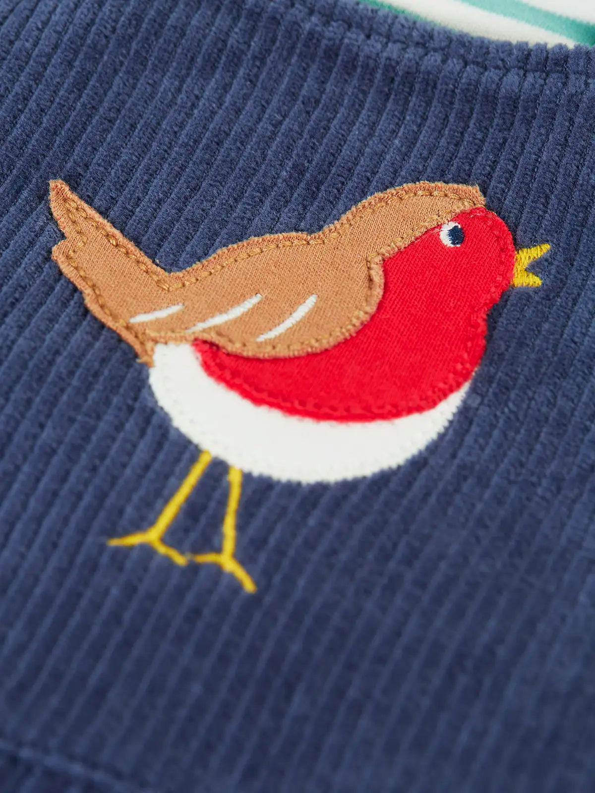 Close up of the robin applique on the Frugi veryan organic cotton navy cord dungarees.