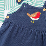 Close up of the Frugi veryan organic cotton navy cord dungaree with robin applique with long sleeve green and white striped bodysuit baby outfit showing the dungaree strap open.