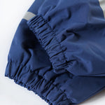 The back of the Frugi Children's Little Waterproof Dungarees - Navy Blue showing the elastic section on the back