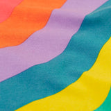 Close up of the Frugi ric rac rainbow organic cotton material on the wide leg children's trousers. 