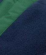 A close up of the navy fleece lining on the Frugi Wilderness green trousers with navy blue coloured knee patches.