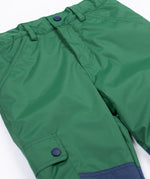 A close up of the Frugi Wilderness green trousers with navy blue coloured knee patches.