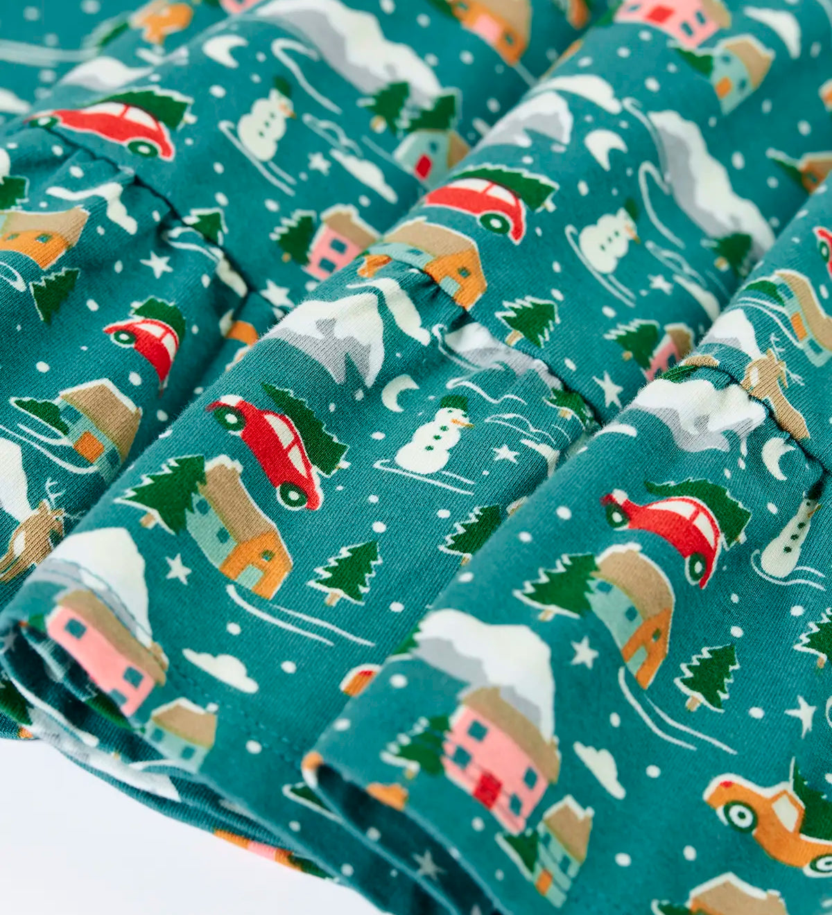Close up of the all over Winter drives print on the Frugi organic cotton Annika long sleeve skater dress.