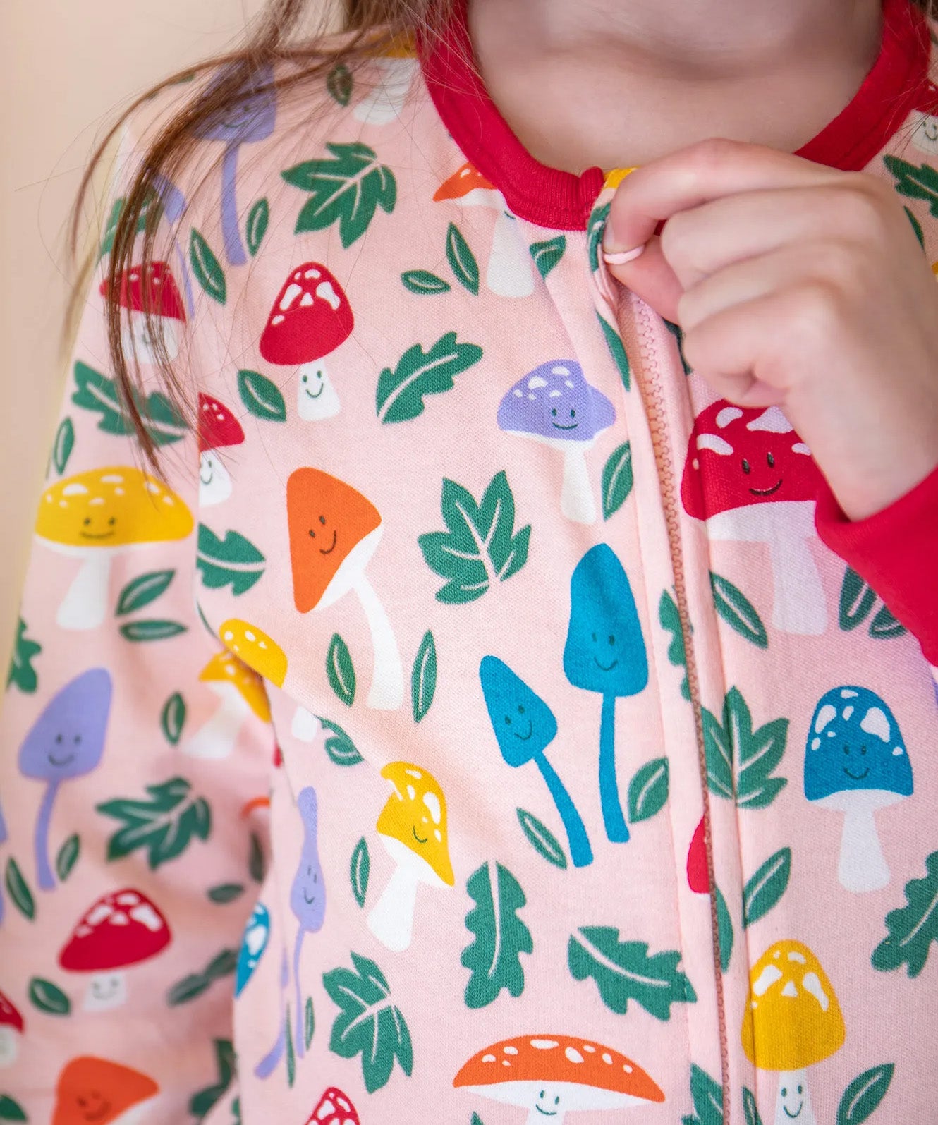 A closeup of the fun guys toadstool print on the Frugi organic cotton Zelah Zip Up Onesie.