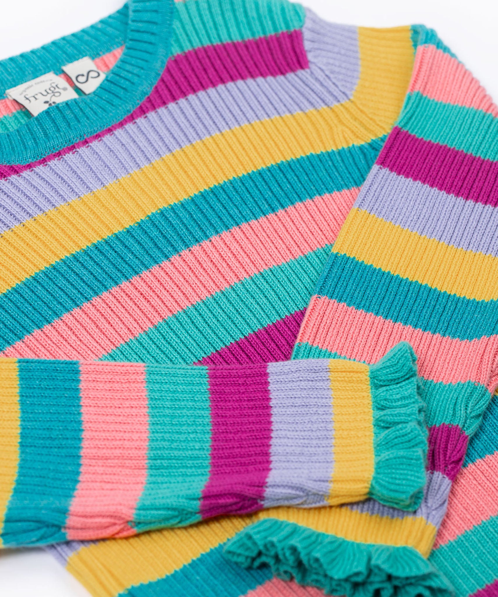 The Frugi Zoe knitted jumper wild rainbow stripe top. This child's top is made with organic cotton. The photo shows a zoomed in photo focusing on the sleeves which have turquoise frilled detail on them. 
