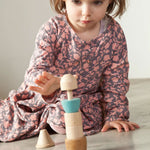 A child playing with the Grapat Stacking Figure.