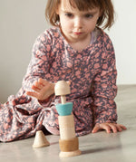 A child playing with the Grapat Stacking Figure.