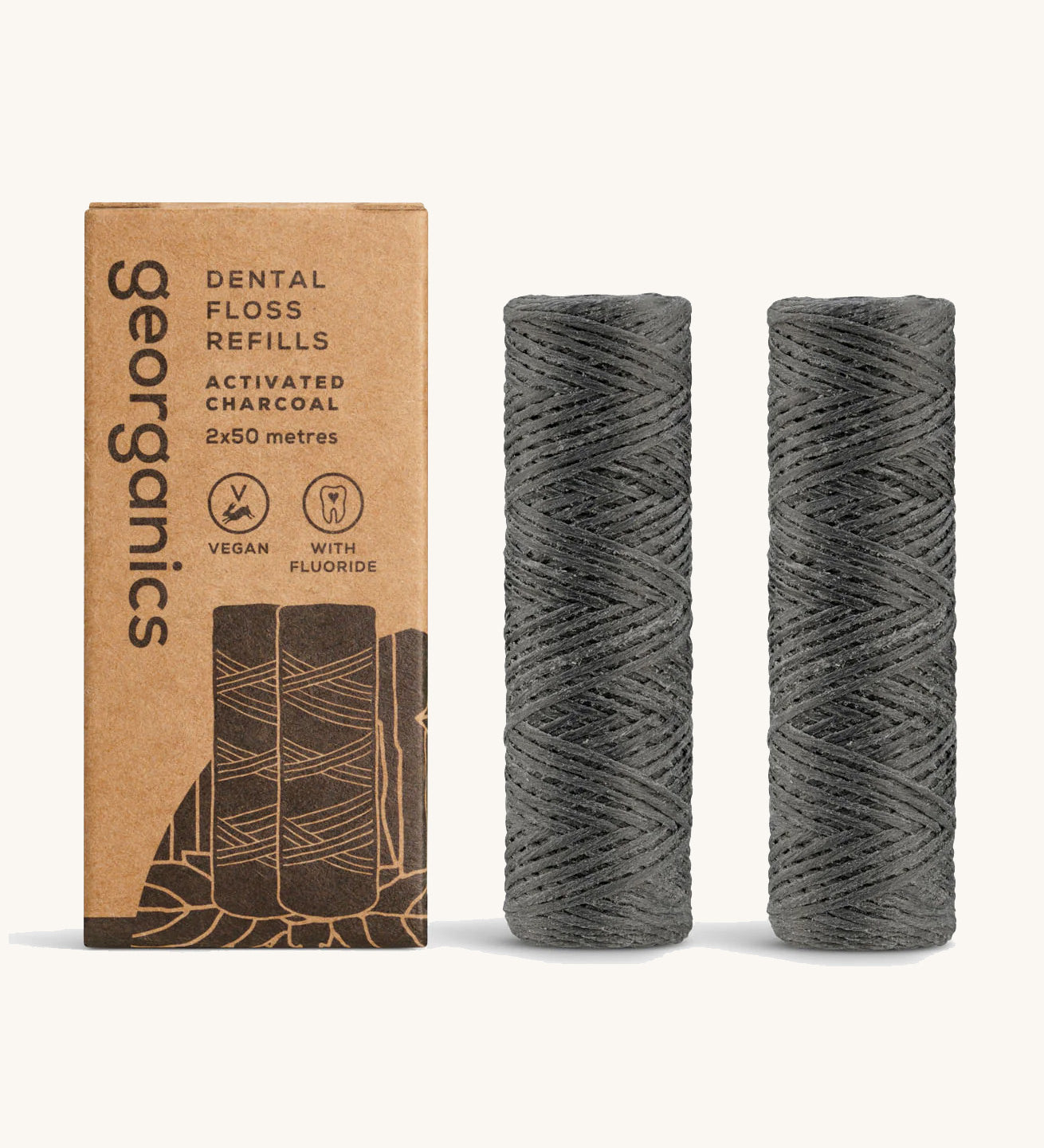 Georganics activated charcoal fluoride dental floss refill tubes, next to cardboard packaging.