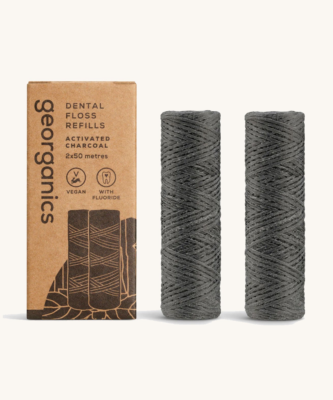 Georganics activated charcoal fluoride dental floss refill tubes, next to cardboard packaging.