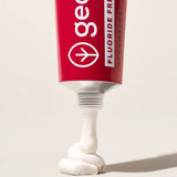Tube of Georganics fluoride free strawberry hydroxyapatite toothpaste showing contents coming out of the nozzle