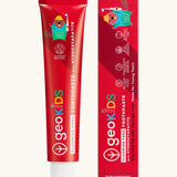 Front of the Georganics strawberry hydroxyapatite fluoride free toothpaste tube next to matching branded packaging 