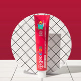 Tube of Georganics strawberry hydroxyapatite toothpaste tube on a tile style floor and matching red background.