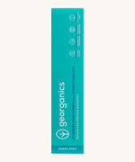 Front view of the Georganics activated charcoal hydroxyapatite toothpaste cardboard packaging, light green box with white and blue branding text. 