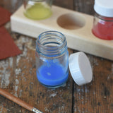 50ml Glass paint jar pot with some blue paint inside. 