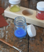 50ml Glass paint jar pot with some blue paint inside. 