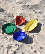 The Glückskäfer Metal Sand Moulds placed on sand.
