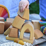 A child playing with the blocks from the Glückskäfer 17 Large Natural Blocks set. 
