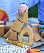 A child playing with the blocks from the Glückskäfer 17 Large Natural Blocks set. 