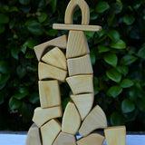 Glückskäfer 17 small natural blocks stacked up into a tall tower.