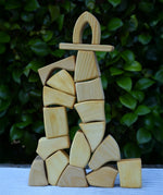 Glückskäfer 17 small natural blocks stacked up into a tall tower.