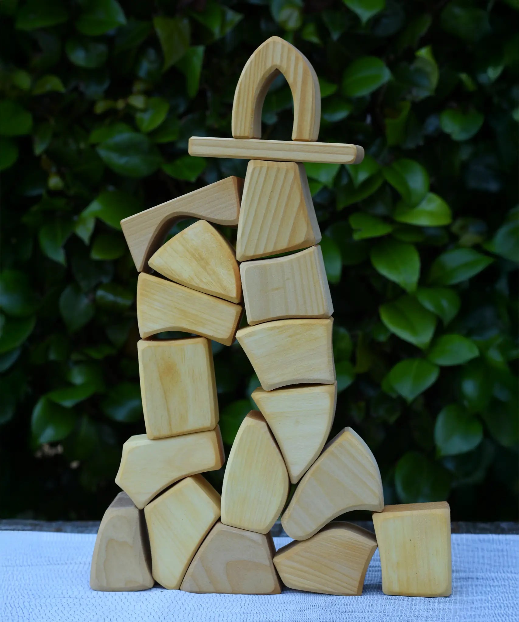 Glückskäfer 17 small natural blocks stacked up into a tall tower.