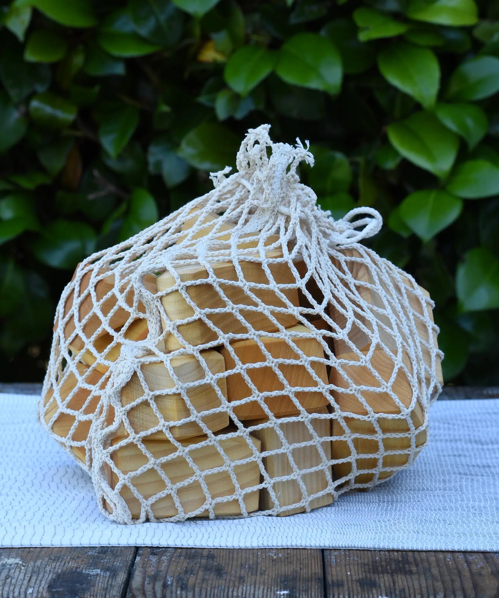 Glückskäfer 17 small natural blocks in their string storage net bag.