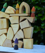 Glückskäfer 17 small natural blocks stacked up with Grapat Tomten Nins placed on them.