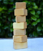 7 blocks from the Glückskäfer 17 small natural blocks set stacked up on their side. 