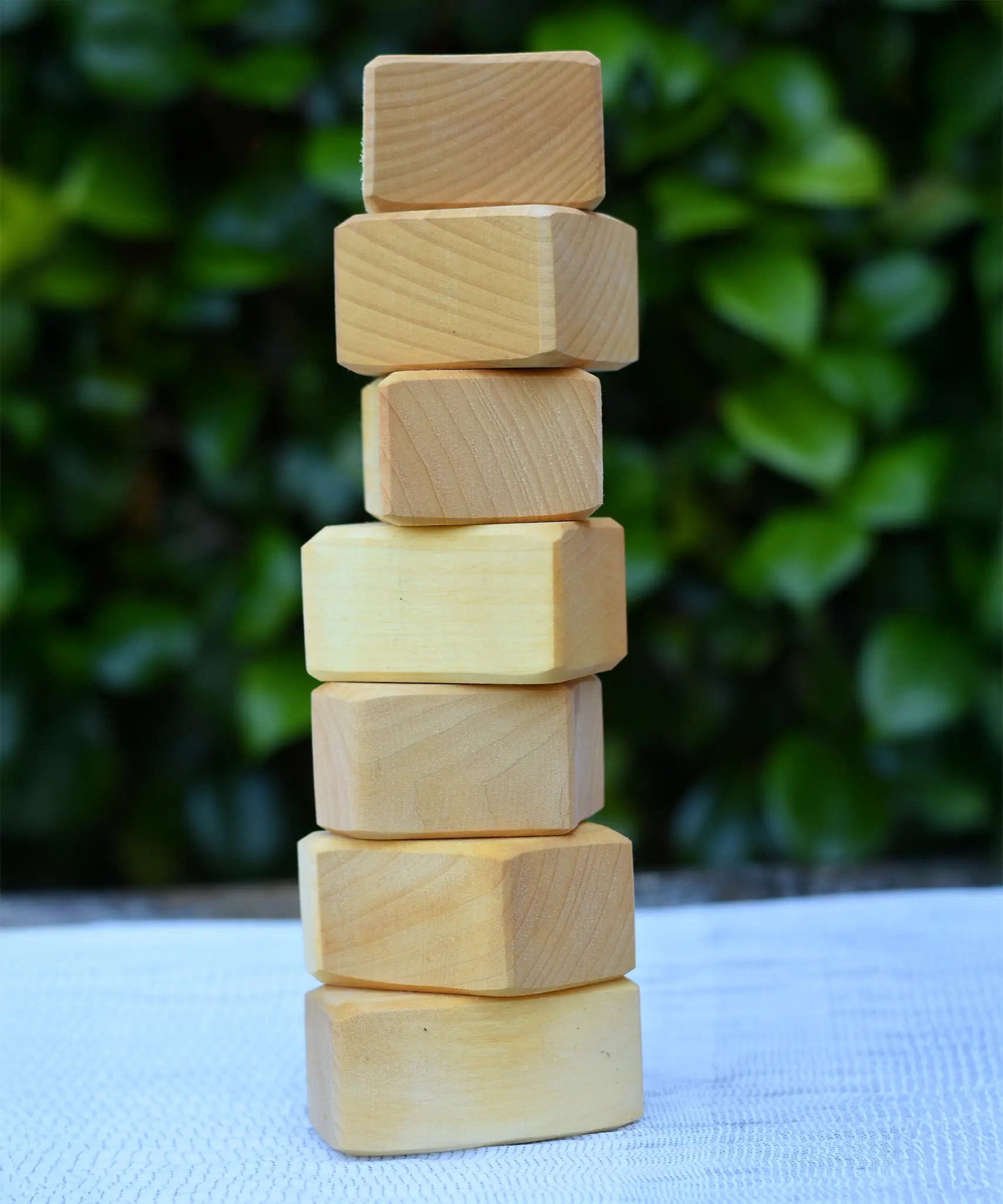 7 blocks from the Glückskäfer 17 small natural blocks set stacked up on their side. 