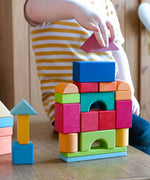 A child building with the blocks from the Glückskäfer 27 Piece Building Blocks Set.