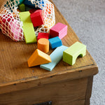 A Glückskäfer 27 Piece Building Blocks Set shown with the string storage next that it comes in. 